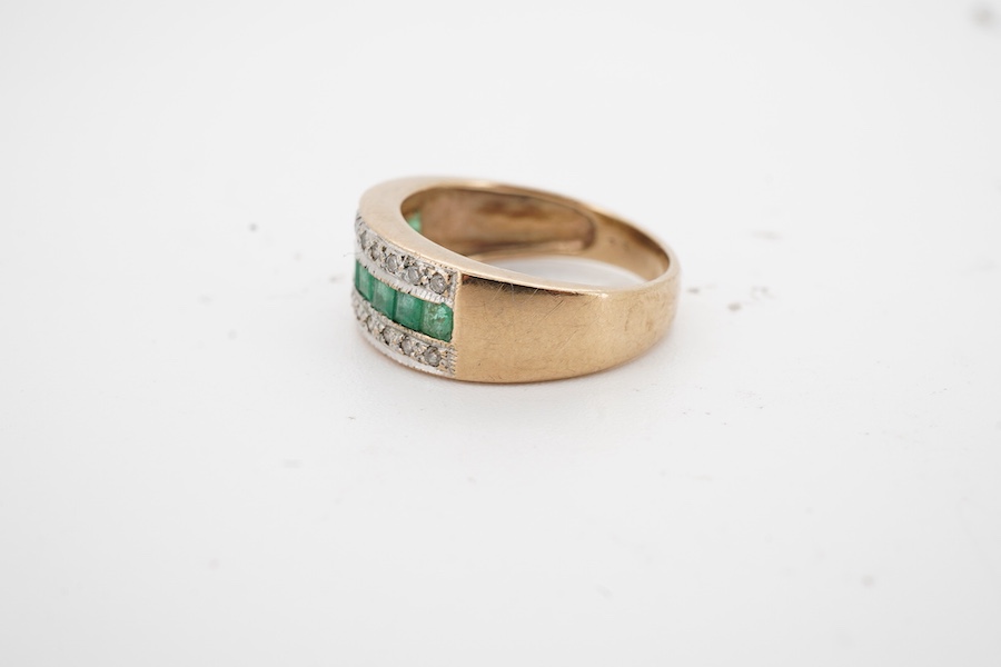 An emerald and diamond half hoop ring, channel-set to the front with calibré-cut emeralds, between lines of brilliant-cut diamonds, mounted in gold, size J, gross weight approximately 2.5 grams